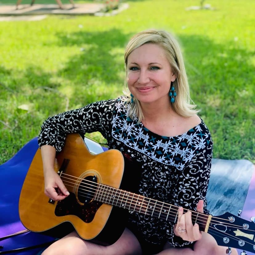 Jessie Trofe playing guitar outdoors